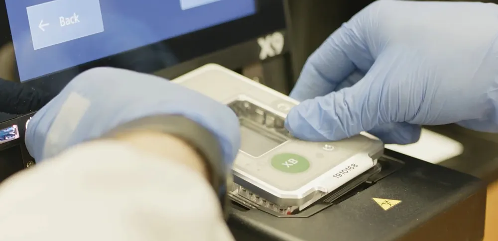 Scientist loading samples into Biomark X9 sample tray